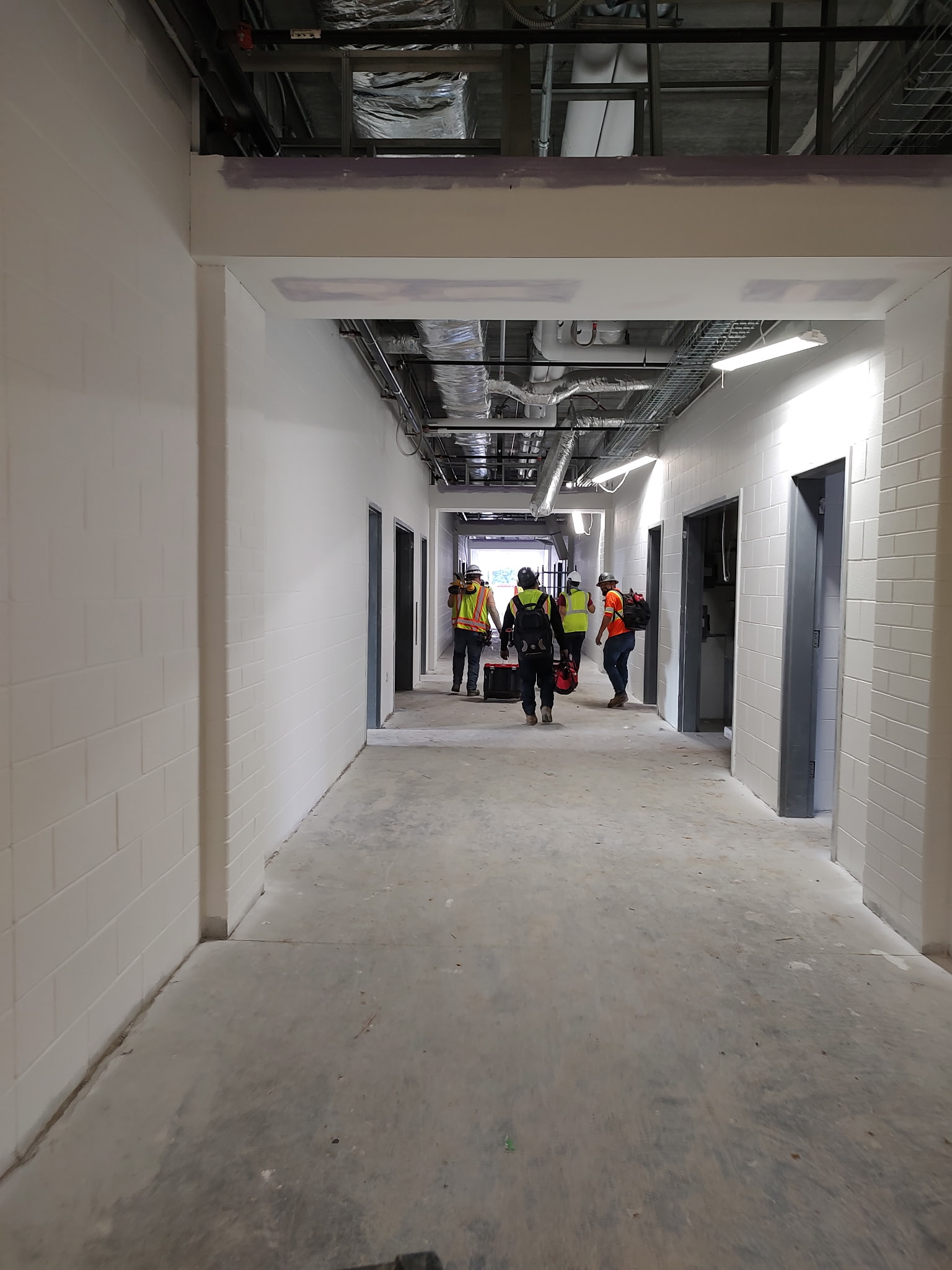 Electrical construction work in a commercial building corridor